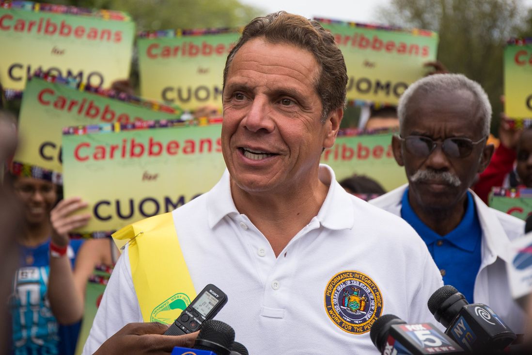 Governor Cuomo with his "Caribbeans for Cuomo" signs<br>